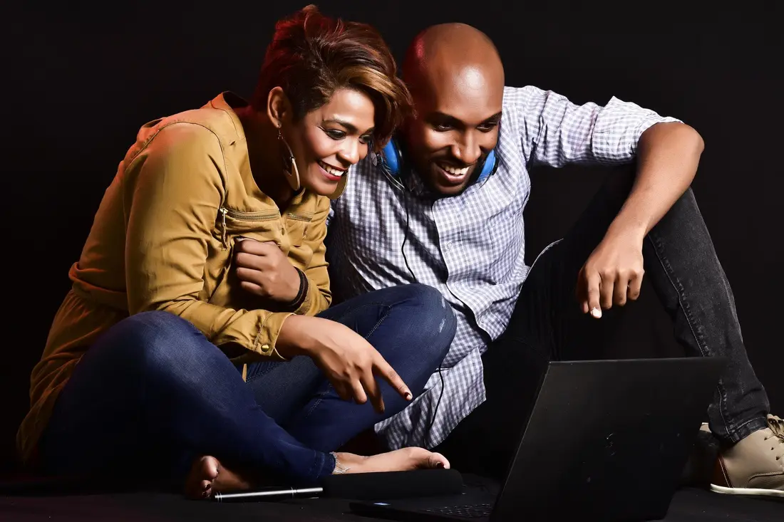 A couple laughing at a video