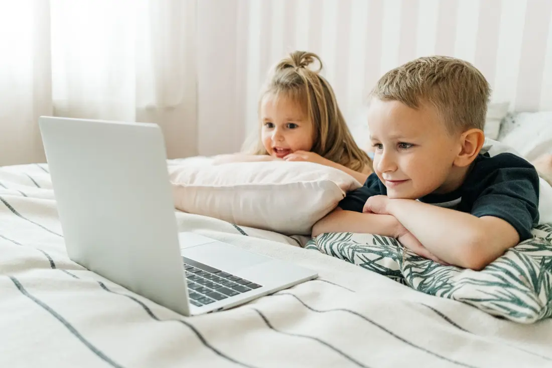 Kids watching a video on a laptop